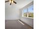 Bright bedroom with large window and neutral colored carpet at 13846 Harrison Dr, Thornton, CO 80602