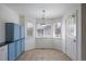 Bright breakfast nook with tile floors and blue accent cabinets at 13846 Harrison Dr, Thornton, CO 80602