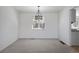 Dining room with neutral carpet, modern light fixture, and bright, white walls at 13846 Harrison Dr, Thornton, CO 80602