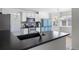 Open kitchen concept with granite countertops and stainless steel faucet at 13846 Harrison Dr, Thornton, CO 80602