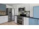 Modern kitchen with stainless steel appliances and white cabinets at 13846 Harrison Dr, Thornton, CO 80602
