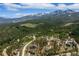 Breathtaking aerial view of a mountain neighborhood surrounded by lush evergreen trees and majestic mountains at 60 Barton Ridge Dr, Breckenridge, CO 80424