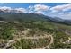 Breathtaking aerial view of a mountain neighborhood surrounded by lush evergreen trees and majestic mountains at 60 Barton Ridge Dr, Breckenridge, CO 80424