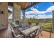 Back deck featuring a stone fireplace, seating, and mountain views at 60 Barton Ridge Dr, Breckenridge, CO 80424