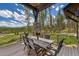 Outdoor back deck boasting mountain views, tall timber, and seating for six at 60 Barton Ridge Dr, Breckenridge, CO 80424