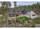 Back exterior of mountain home with outdoor bar and grill, and a neatly manicured lawn at 60 Barton Ridge Dr, Breckenridge, CO 80424