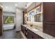 This bathroom has granite counters, dark wood cabinets, a free standing tub, and lots of natural light at 60 Barton Ridge Dr, Breckenridge, CO 80424