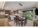 Open dining room with backyard views, modern lighting, and seating for six adjacent to the kitchen at 60 Barton Ridge Dr, Breckenridge, CO 80424
