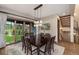 Dining room showcasing a large wooden table, backyard views, and stairs to the second level at 60 Barton Ridge Dr, Breckenridge, CO 80424
