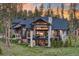 Stunning mountain home boasts an inviting exterior with natural wood and stone accents and beautiful sunset views at 60 Barton Ridge Dr, Breckenridge, CO 80424