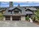 Stunning home with a dark roof, wooden siding, stone accents and attached two car garage at 60 Barton Ridge Dr, Breckenridge, CO 80424