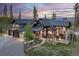 Grand mountain home at dusk with private balconies, ample windows, and lush surrounding landscape at 60 Barton Ridge Dr, Breckenridge, CO 80424