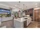 Bright, open kitchen with stainless appliances, center island, and views of the living area and outside landscape at 60 Barton Ridge Dr, Breckenridge, CO 80424