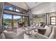 This living room boasts large windows with mountain views, plush seating, and stylish décor for relaxation and enjoyment at 60 Barton Ridge Dr, Breckenridge, CO 80424