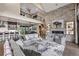 Open concept living space features a stone fireplace, balcony, modern kitchen, and dining area for seamless entertaining at 60 Barton Ridge Dr, Breckenridge, CO 80424