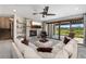Spacious living room with a stone fireplace, cozy sofa, and large windows showcasing beautiful outdoor scenery at 60 Barton Ridge Dr, Breckenridge, CO 80424