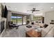 Open-concept living room with a stone fireplace, comfortable seating, and large windows offering scenic views at 60 Barton Ridge Dr, Breckenridge, CO 80424
