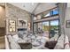 This living room features a stone accent wall, fireplace, and expansive windows offering stunning mountain views at 60 Barton Ridge Dr, Breckenridge, CO 80424