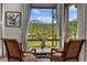 Breathtaking mountain views from the window, framed by cozy chairs and elegant curtains, creating a serene retreat at 60 Barton Ridge Dr, Breckenridge, CO 80424
