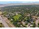 Wide aerial view of the neighborhood with mature trees and mountains at 7346 S Platte Canyon Dr, Littleton, CO 80128