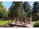 Charming backyard bridge with lush greenery and scenic landscaping at 7346 S Platte Canyon Dr, Littleton, CO 80128
