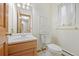 Powder room featuring a single sink vanity, tile floor, and medicine cabinet at 7346 S Platte Canyon Dr, Littleton, CO 80128