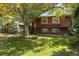 Charming two-story home with a well-manicured lawn and mature trees providing shade at 7346 S Platte Canyon Dr, Littleton, CO 80128