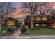 Exterior of home includes brick and siding, mature trees, and beautiful landscaping at 7346 S Platte Canyon Dr, Littleton, CO 80128