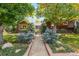 Charming two-story home with brick accents, mature trees, and manicured front yard at 7346 S Platte Canyon Dr, Littleton, CO 80128