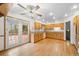 Bright eat-in kitchen boasts wood cabinets, stainless appliances, and access to the outdoor deck at 7346 S Platte Canyon Dr, Littleton, CO 80128