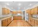 Updated kitchen with oak cabinets, granite countertops, hardwood floors, and modern appliances at 7346 S Platte Canyon Dr, Littleton, CO 80128