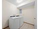 Laundry room with washer and dryer units on tile floors at 7346 S Platte Canyon Dr, Littleton, CO 80128