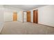 Spacious living room with neutral carpeting and multiple doors at 7346 S Platte Canyon Dr, Littleton, CO 80128