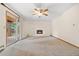 Bright living room featuring neutral carpet, a fireplace, and outdoor access at 7346 S Platte Canyon Dr, Littleton, CO 80128