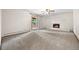 Bright living room featuring neutral carpet, a fireplace, and outdoor access at 7346 S Platte Canyon Dr, Littleton, CO 80128