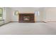 Spacious living room boasts a brick fireplace with a raised hearth and a large window with natural light at 7346 S Platte Canyon Dr, Littleton, CO 80128