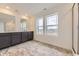 Modern bathroom boasts double vanity and tiled shower with glass door at 8846 Waterleaf Ln, Littleton, CO 80125