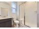 Modern bathroom includes glass shower, toilet, and vanity with storage at 8846 Waterleaf Ln, Littleton, CO 80125