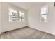 Cozy bedroom offers neutral carpeting and ample natural light through windows at 8846 Waterleaf Ln, Littleton, CO 80125