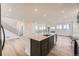 Open-concept kitchen with an island, stainless steel appliances and adjacent living space, perfect for entertaining at 8846 Waterleaf Ln, Littleton, CO 80125