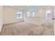 Large carpeted living space with ample natural light from multiple windows creating a welcoming atmosphere at 8846 Waterleaf Ln, Littleton, CO 80125