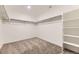 Spacious walk-in closet with ample shelving and carpeted floor at 8846 Waterleaf Ln, Littleton, CO 80125