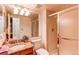Bathroom with granite countertop vanity, toilet, and glass-enclosed shower at 9614 W Powers Cir, Littleton, CO 80123