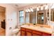 Bright bathroom features a double sink vanity and a window offering natural light at 9614 W Powers Cir, Littleton, CO 80123