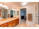 Bathroom with a walk-in shower, and double vanity sinks with neutral countertops at 9614 W Powers Cir, Littleton, CO 80123