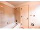 Bathtub with shower and tiled wall at 9614 W Powers Cir, Littleton, CO 80123