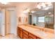 Bathroom features double sinks, granite countertops, and a large mirror and lighting at 9614 W Powers Cir, Littleton, CO 80123