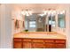 Bathroom features double sinks, granite countertops, and a large mirror and lighting at 9614 W Powers Cir, Littleton, CO 80123