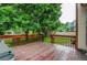 View of wooden deck, lush backyard, and surrounding trees at 9614 W Powers Cir, Littleton, CO 80123