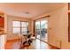 Dining area with modern table set and sliding glass doors leading to an outdoor deck at 9614 W Powers Cir, Littleton, CO 80123